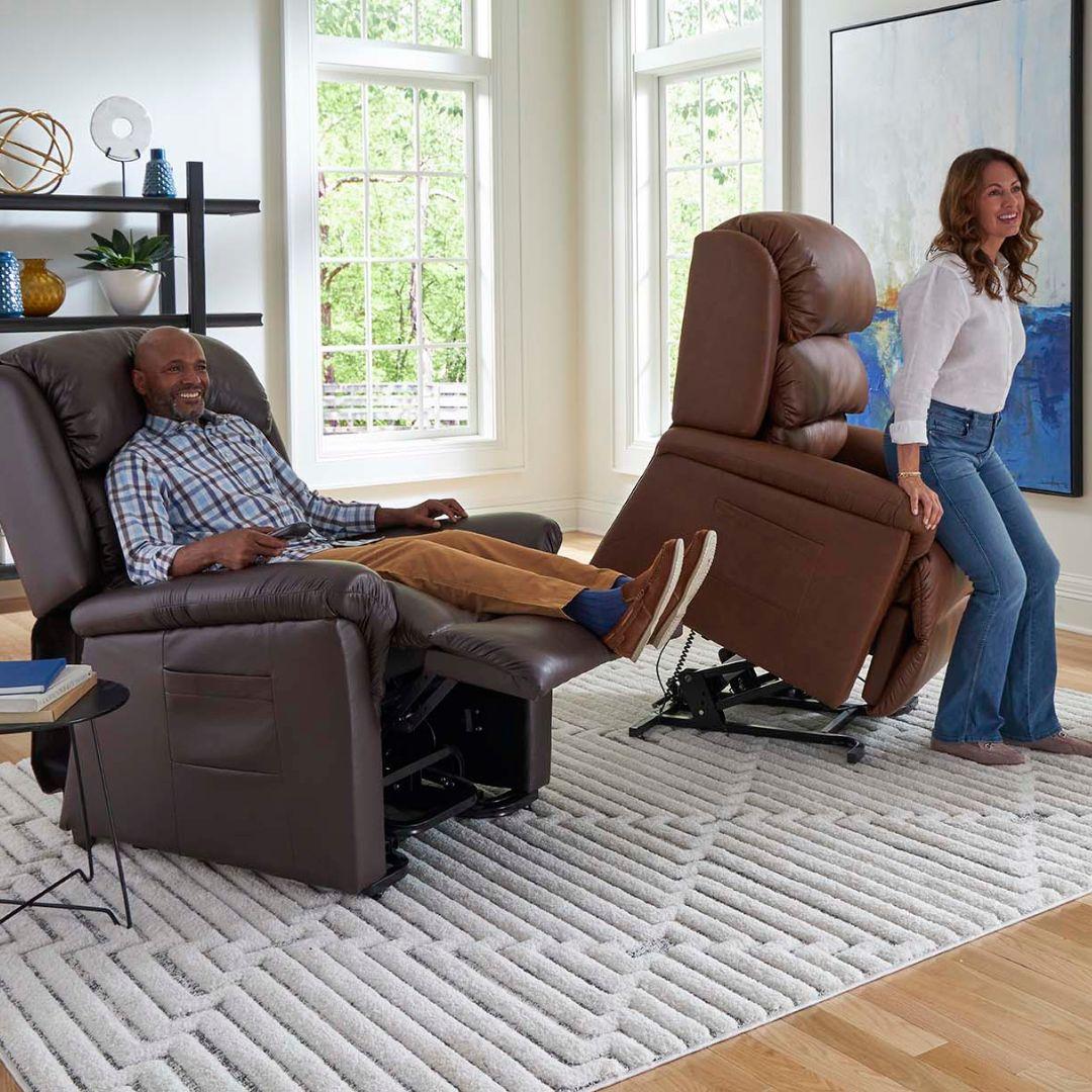 Two people using Golden Technologies Relaxer PR-766 w/ MaxiComfort Lift Chair Recliners in a living room with large windows and a rug.
