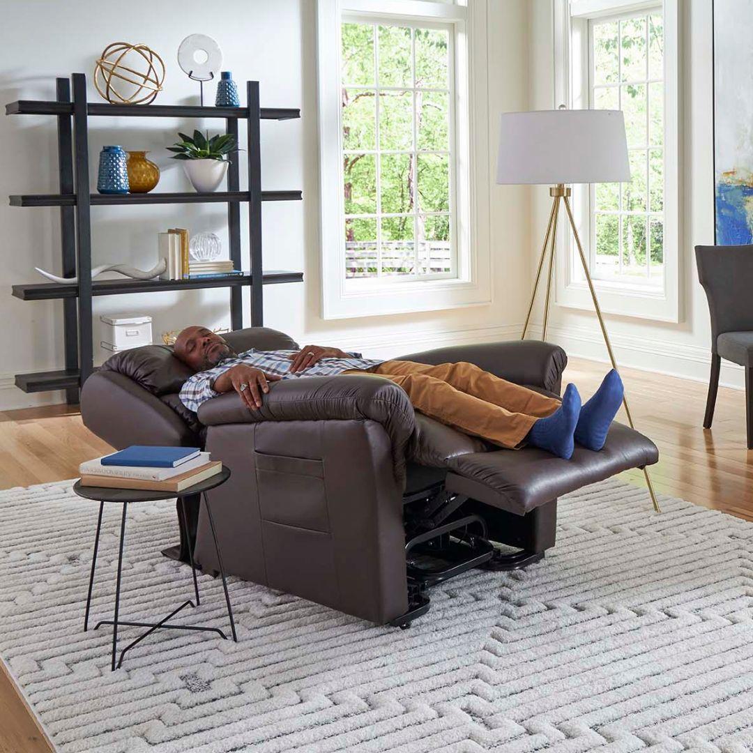 Man relaxing on a Golden Technologies Relaxer PR-766 w/ MaxiComfort Lift Chair Recliner Close Up in a bright living room with large windows.
