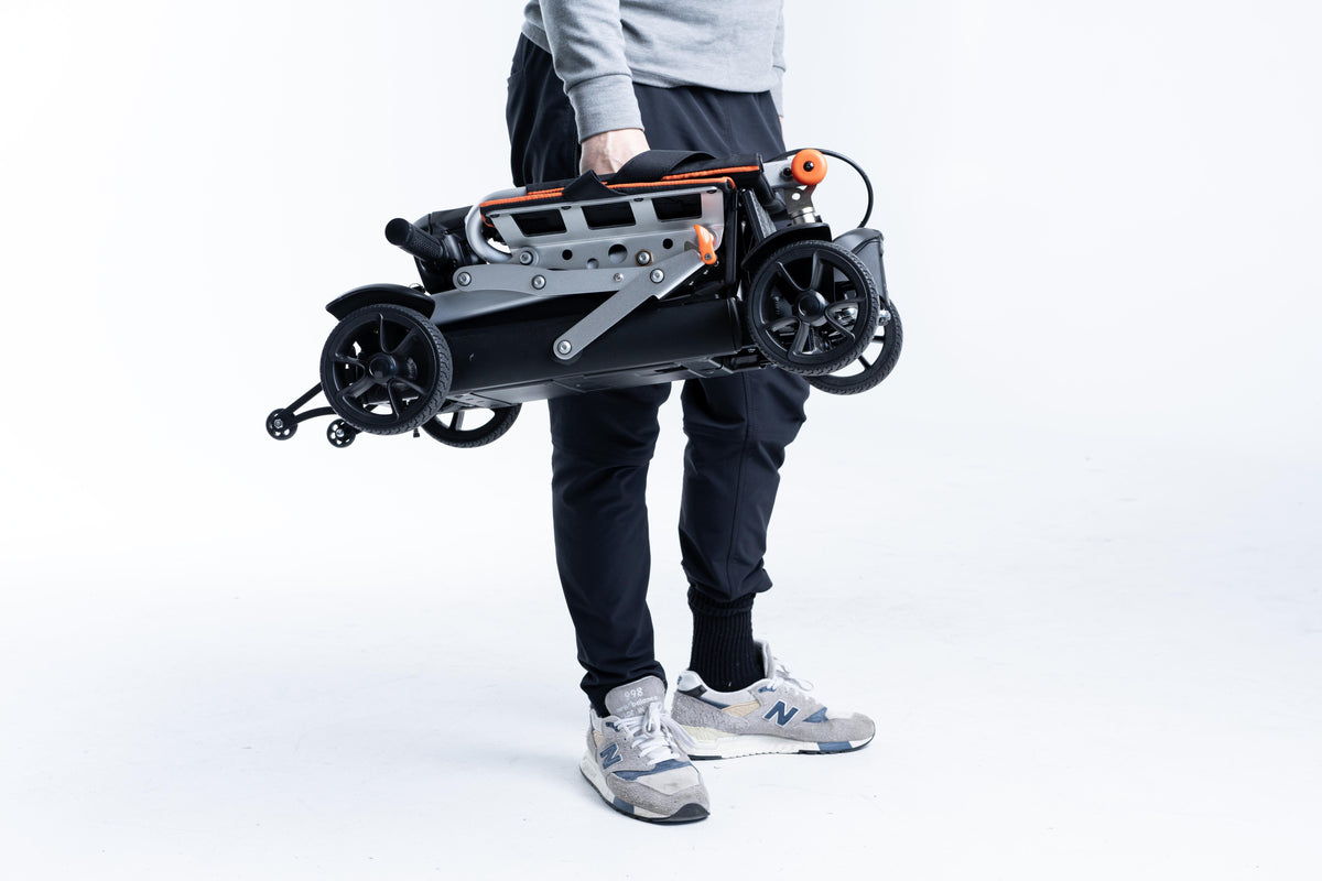 Man Lifting Feather 27X Folding Mobility Scooter With One Hand