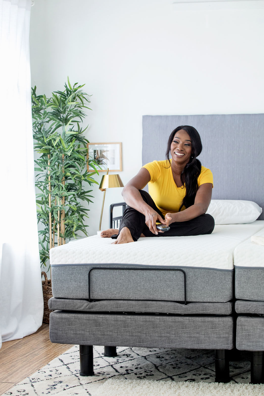 Woman Sitting on Golden Passport Hi Low Adjustable Bed 