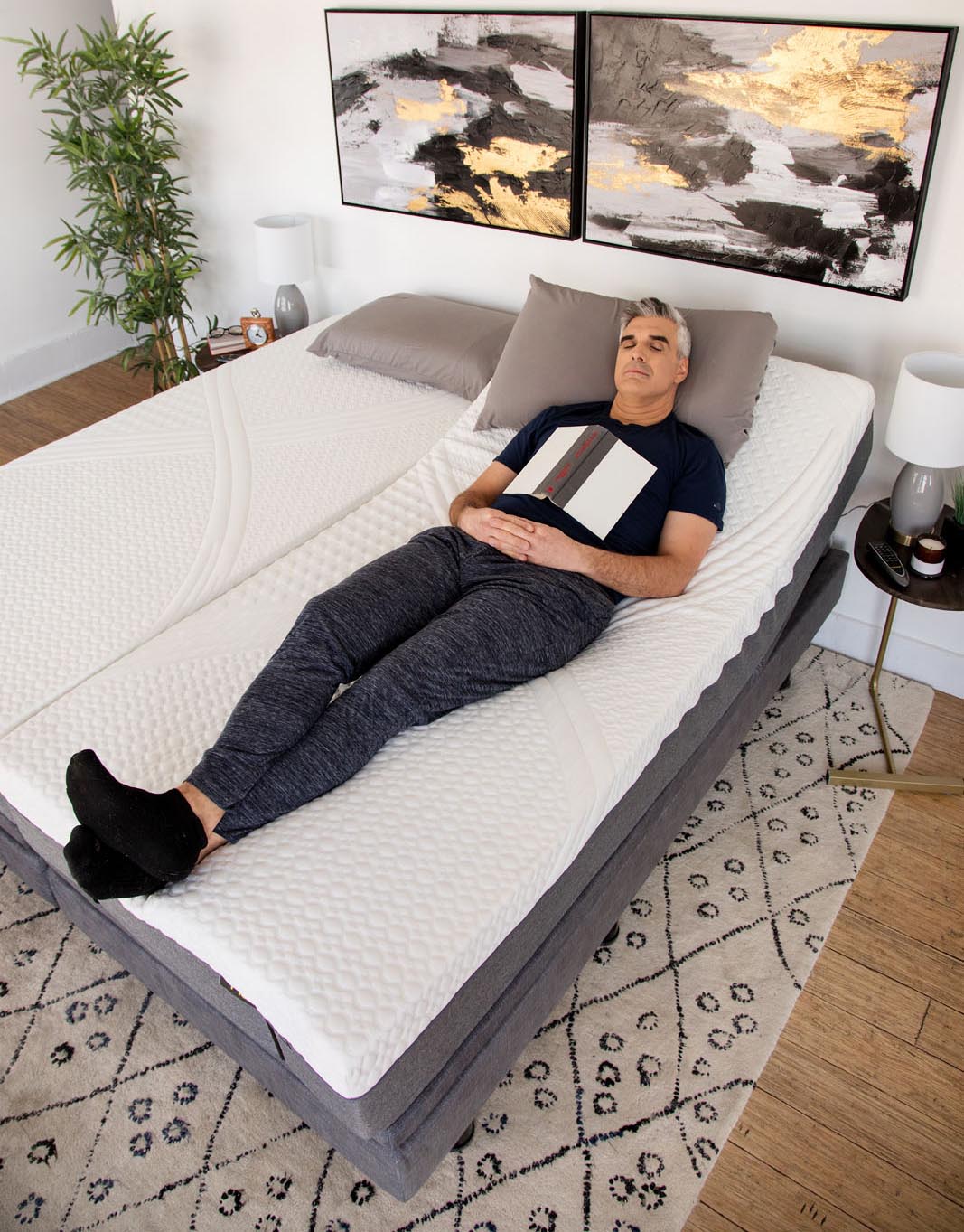 Man Sleeping on Golden Passport Hi Low Adjustable Bed 