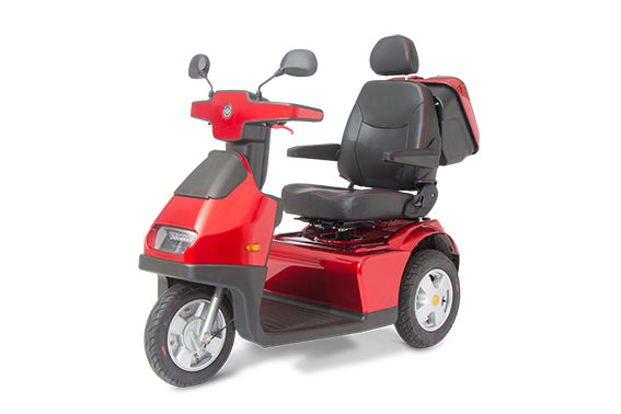 A red Afikim Afiscooter S3 with canopy, a 3-wheel outdoor heavy-duty mobility scooter.