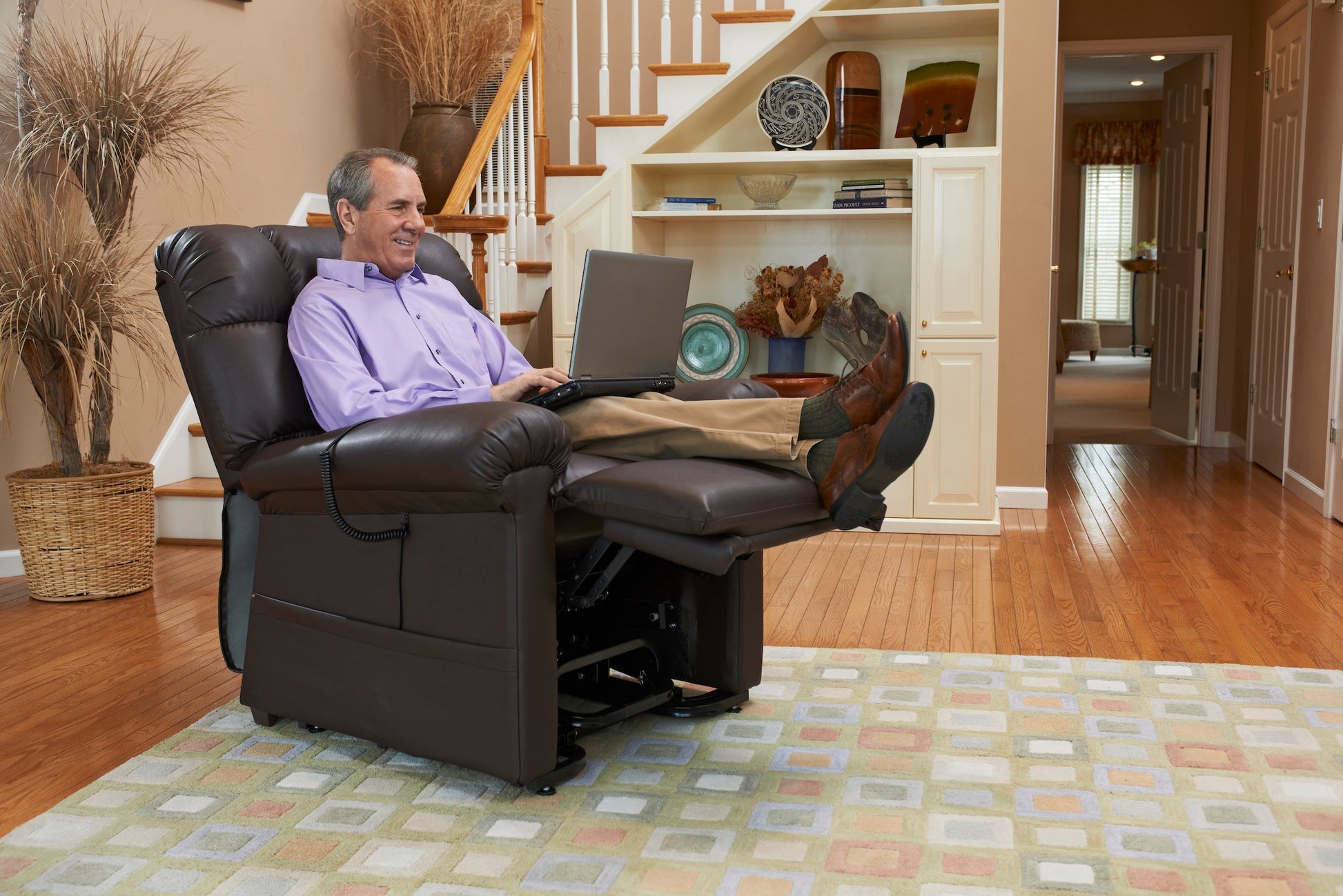 Man using a laptop in a Cloud PR510 Lift Chair Recliner with Maxicomfort by Golden Technologies