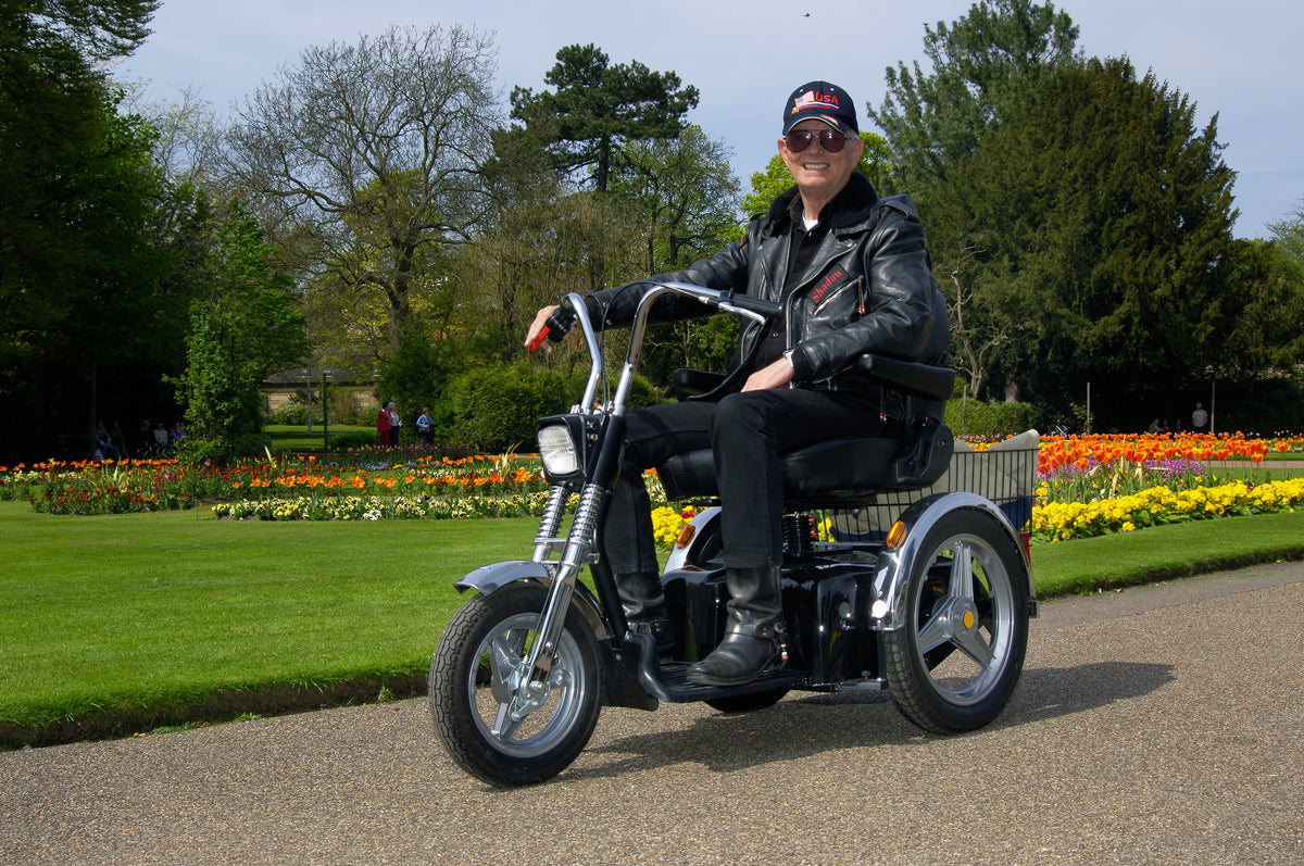 Senior Man Riding Afikim Afiscooter SE Three Wheel Recreational Mobility Scooter