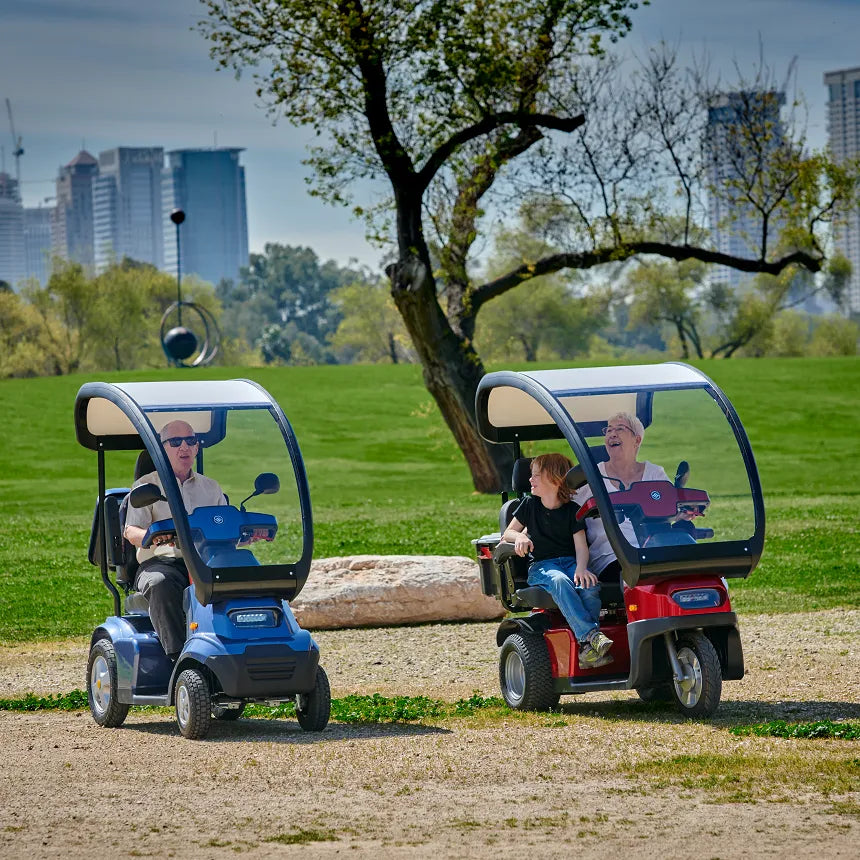 Seniors Riding Afikim Afiscooter S4 with Canopy